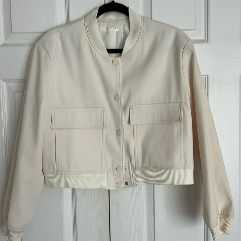 Cream color bomber jacket.